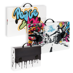 Three art-themed briefcases are shown. One is white with Peace & Love in colorful graffiti, another has a street art scene with vibrant colors, and the third is black and white with a paint-drip design.